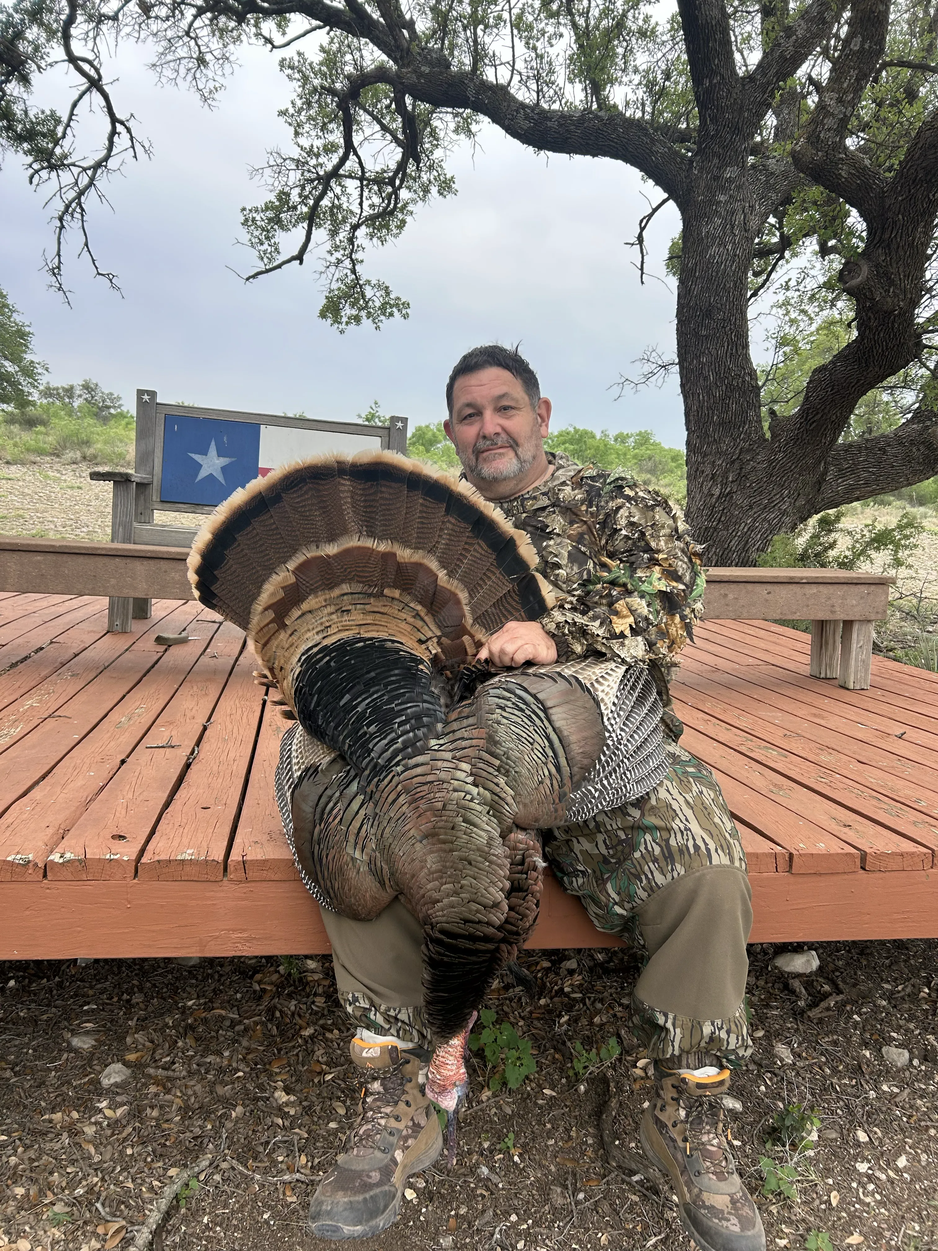 Buck running through tall prairie grass